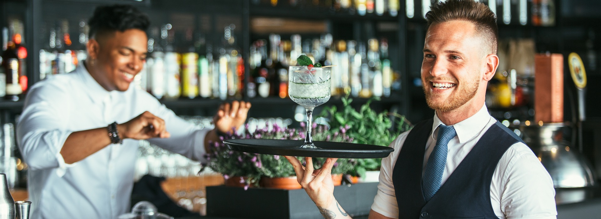 Smiling waiter with a cocktail jpg